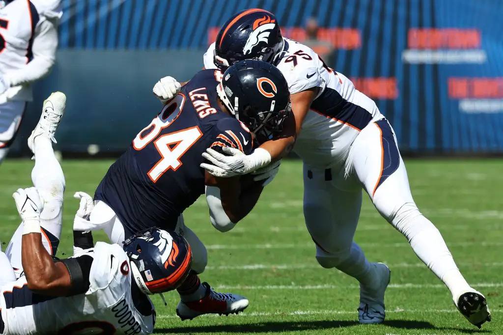 Denver Broncos defensive tackle Elijah Garcia (95) tackles Chicago Bears tight end Marcedes Lewis (84) during the second half at Soldier Field. 