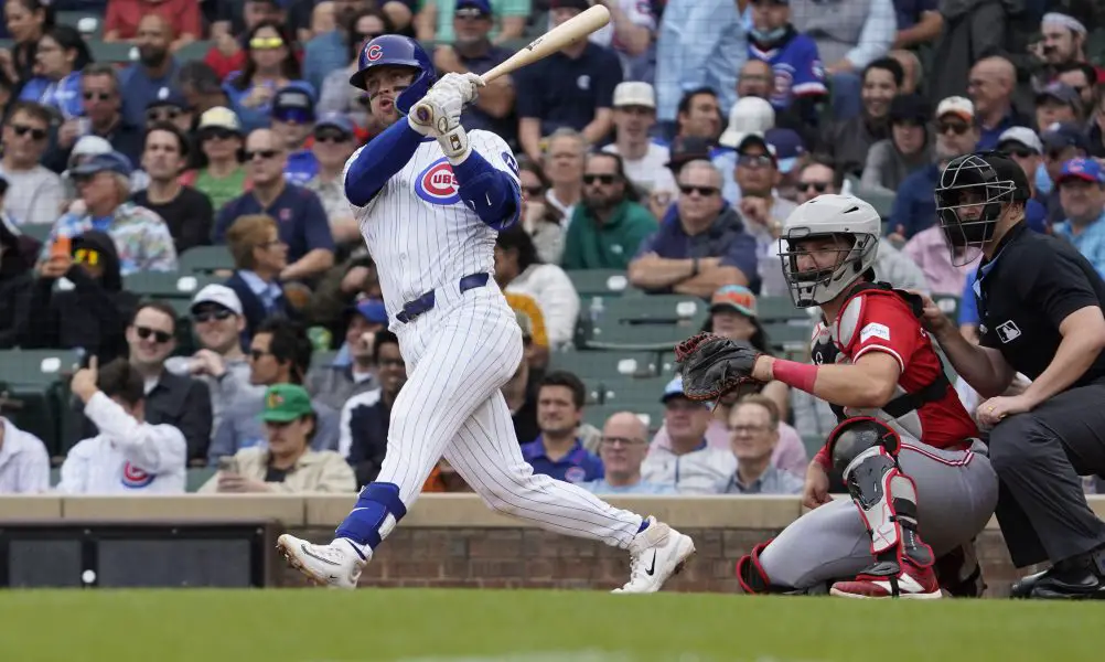 Chicago Cubs second baseman Nico Hoerner (2) hits a double against the Cincinnati Reds during the fifth inning at Wrigley Field. Mandatory