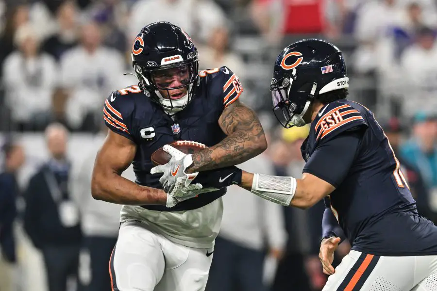 Chicago Bears Caleb Williams making a hand off to DJ Moore 