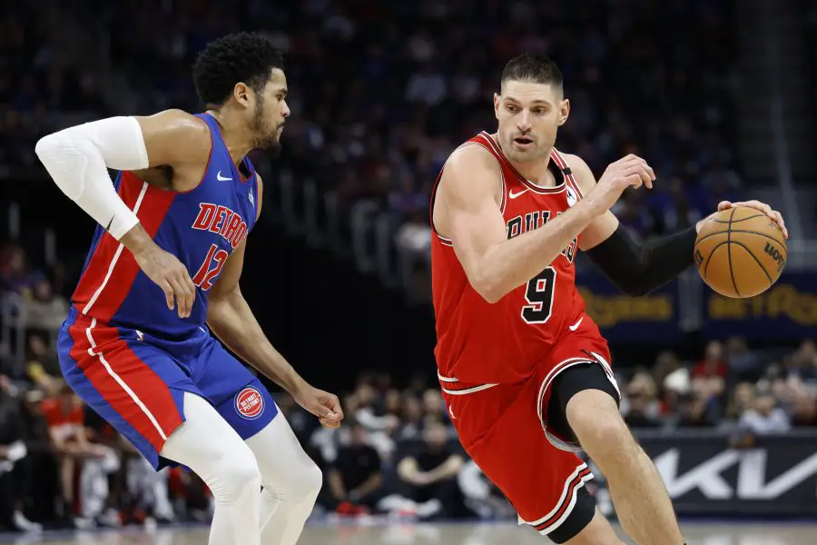 Chicago Bulls center Nikola Vucevic (9) dribbles defended by Detroit Pistons forward Tobias Harris.