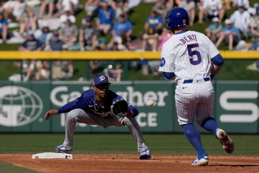 Los Angeles Dodgers shortstop Mookie Betts (50) gets the force out on Chicago Cubs third base Jon Berti (5) during the second inning at Sloan Park.