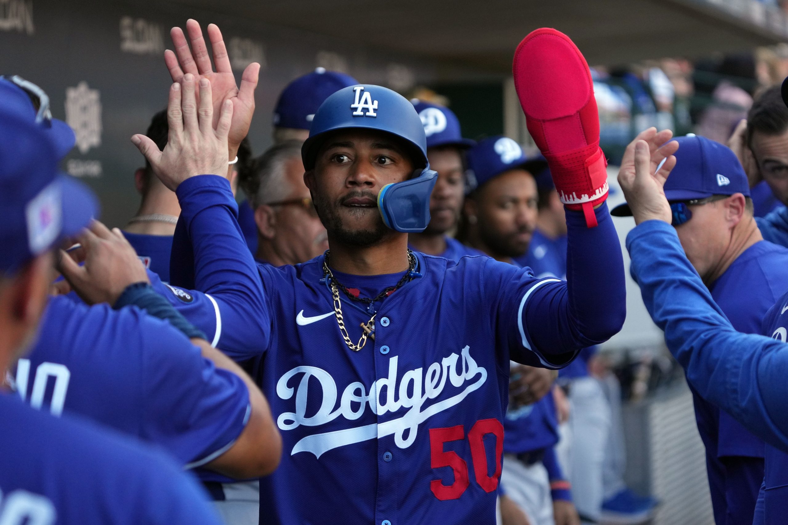 Los Angeles Dodgers shortstop Mookie Betts (50) celebrates with teammates after scoring a run against the Chicago Cubs during the third inning at Sloan Park. 