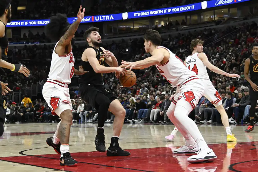 Cleveland Cavaliers forward De'Andre Hunter (12) drives to the basket against Chicago Bulls guard Coby White (0) and forward Zach Collins (12) during the second half at United Center