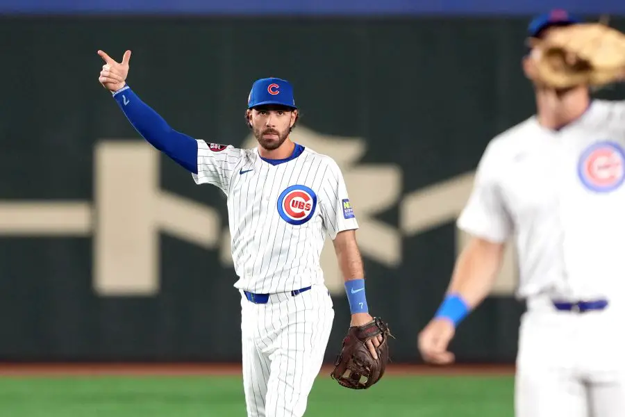 Chicago Cubs shortstop Dansby Swanson (7) gestures after making a diving stop against the Yomiuri Giants during the first inning at Tokyo Dome.